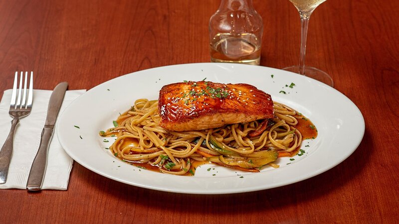 Salmon entree on a bed of pasta