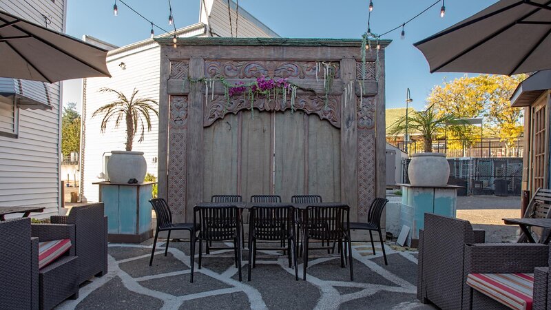 Outdoor dining area with view of table set for eight