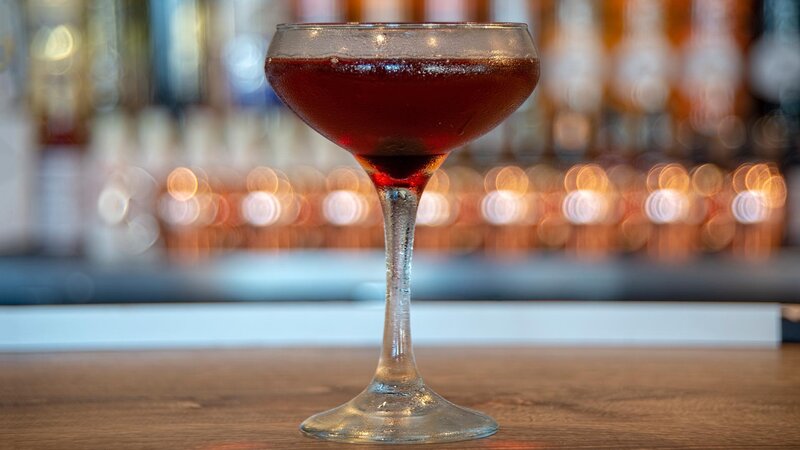 Red cocktail in a martini glass