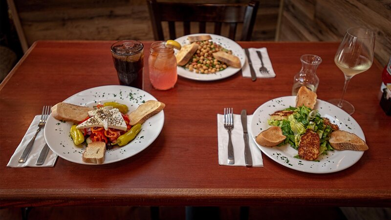 Three plated salads on set table